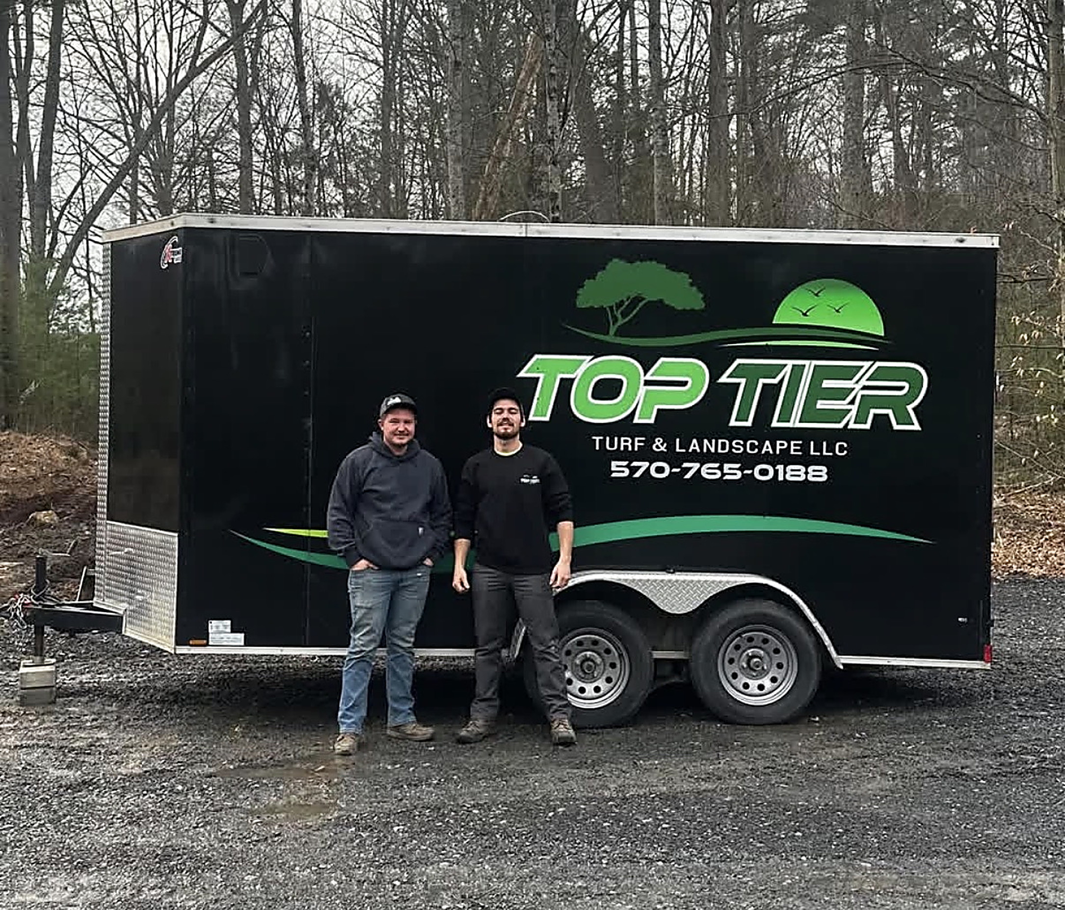 Josh Horst and Kruz Kepner, co-founders of Top Tier Turf & Landscape LLC, with the company trailer